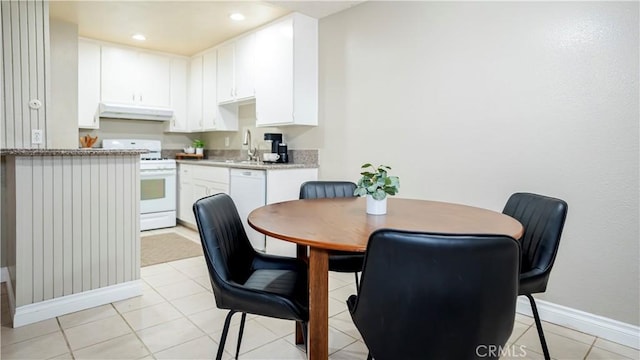 dining room with light tile patterned floors, baseboards, and recessed lighting