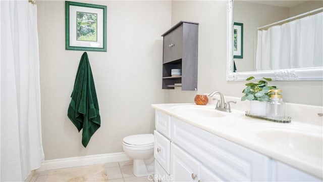 full bath featuring double vanity, toilet, a sink, baseboards, and tile patterned floors