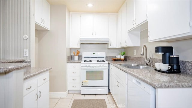 kitchen with white appliances, light tile patterned floors, under cabinet range hood, white cabinetry, and a sink