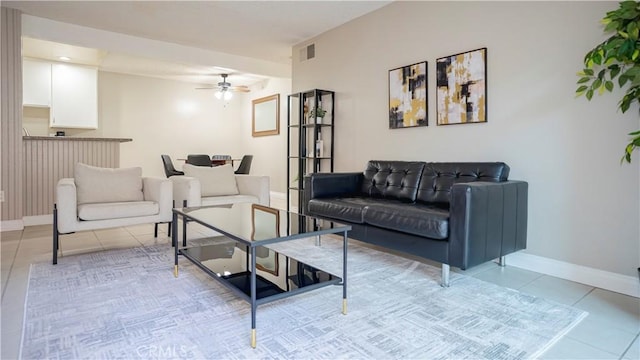 living area with a ceiling fan, visible vents, baseboards, and light tile patterned floors