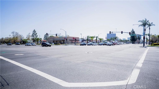 view of road featuring traffic lights and street lighting