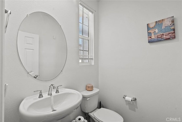 bathroom featuring a sink and toilet