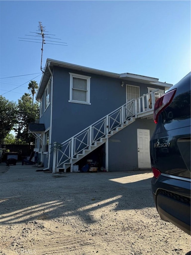 view of front of property featuring stairway