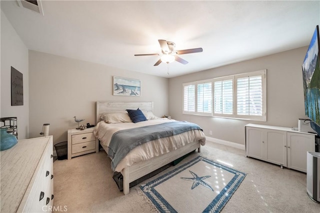 bedroom featuring light carpet, baseboards, visible vents, and ceiling fan