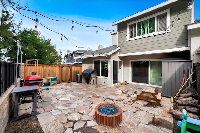 view of patio with an outdoor fire pit, a fenced backyard, and area for grilling