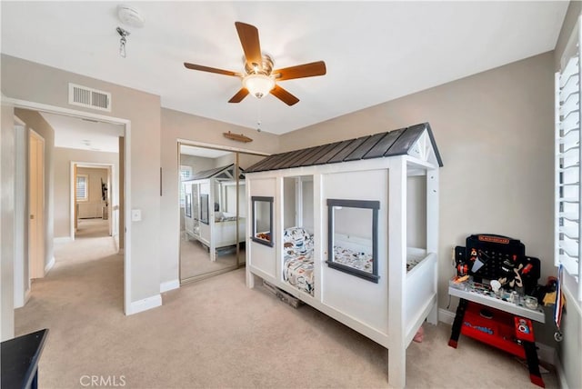 bedroom with light colored carpet, visible vents, and baseboards