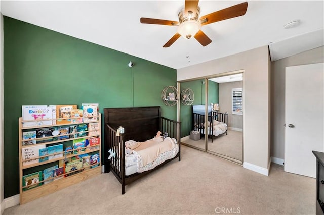 bedroom featuring carpet, a closet, ceiling fan, and baseboards