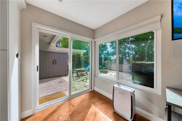 entryway with baseboards and light wood finished floors