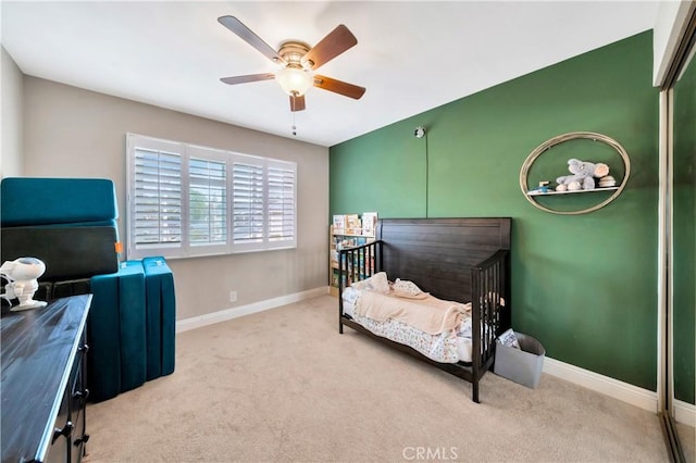 carpeted bedroom with a ceiling fan and baseboards