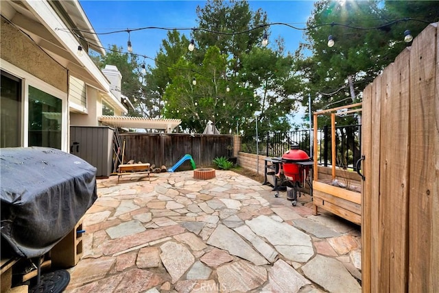 view of patio featuring a grill, a pergola, and a fenced backyard