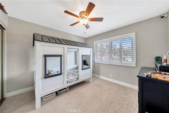 bedroom with a ceiling fan, carpet, and baseboards