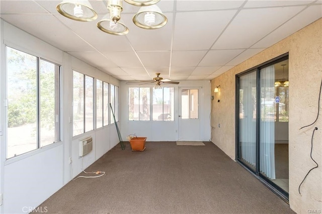 unfurnished sunroom with a drop ceiling, a wealth of natural light, and a ceiling fan