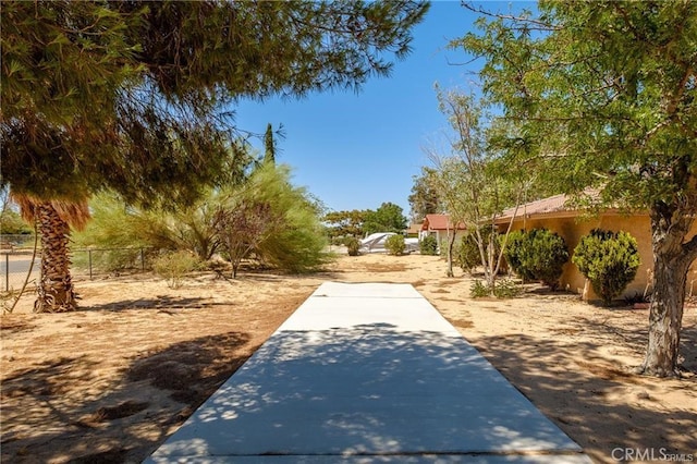 view of property's community featuring fence