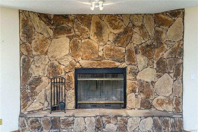 room details featuring a fireplace and a textured ceiling