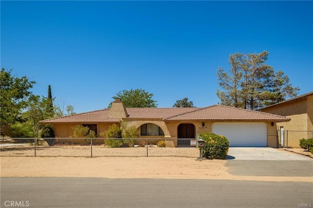 view of front of house with a garage, fence, concrete driveway, a tiled roof, and a chimney