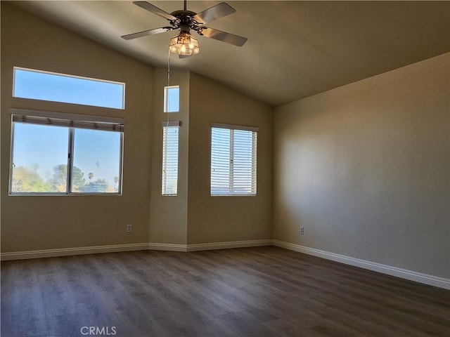 spare room featuring dark wood-style floors, plenty of natural light, and baseboards