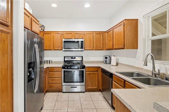 kitchen featuring light tile patterned floors, light countertops, stainless steel appliances, a sink, and recessed lighting