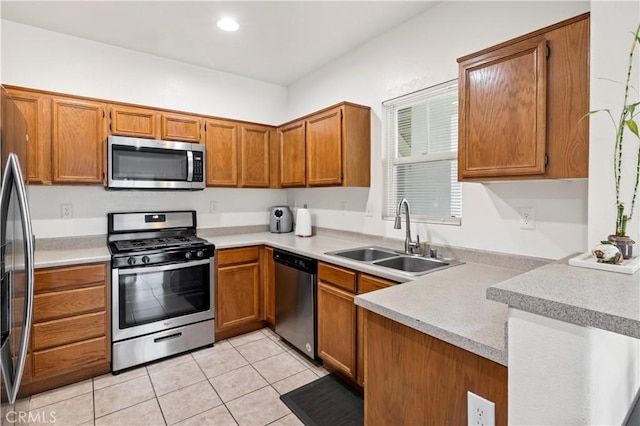 26396 Arboretum Way Unit 2901, Murrieta, CA 92563 - kitchen with appliances with stainless steel finishes, brown cabinetry, a peninsula, light countertops, and recessed lighting