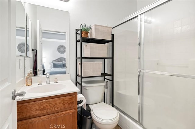 full bath featuring toilet, a stall shower, and vanity