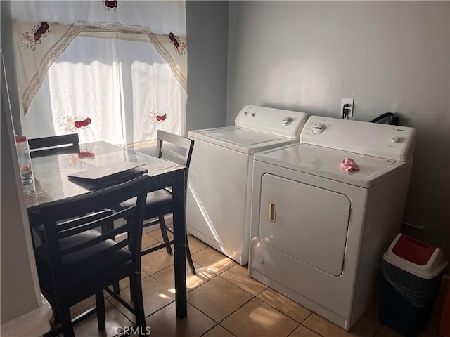 laundry room with washer and dryer, laundry area, and light tile patterned flooring