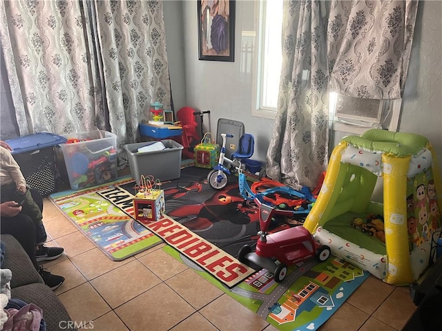 rec room with tile patterned flooring