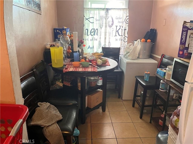 interior space featuring washer / clothes dryer and light tile patterned floors