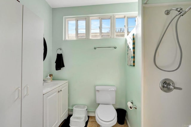 full bath featuring toilet, baseboards, walk in shower, and vanity