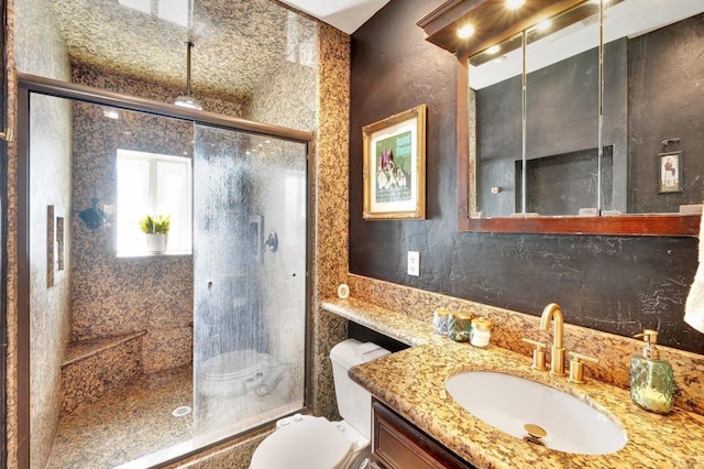 bathroom with tasteful backsplash, a stall shower, vanity, and toilet