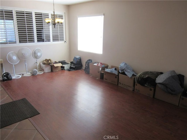 unfurnished dining area with a chandelier and wood finished floors