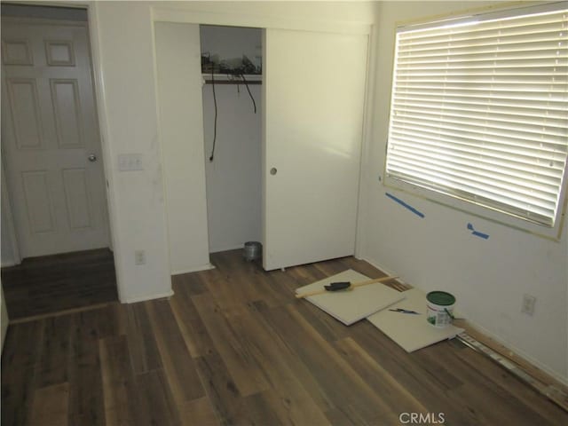 unfurnished bedroom featuring a closet and wood finished floors