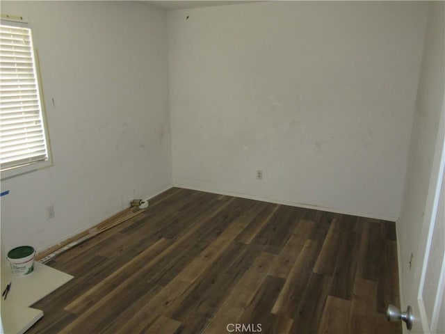 spare room with wood finished floors