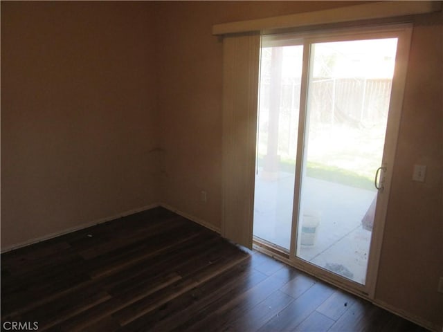 empty room featuring dark wood finished floors