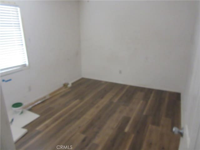 unfurnished room with wood finished floors