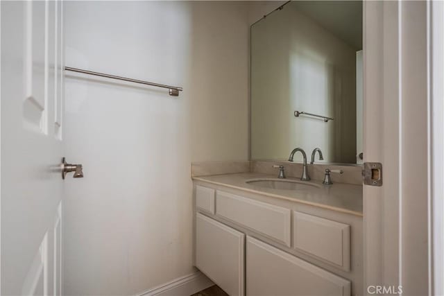 bathroom with vanity and baseboards