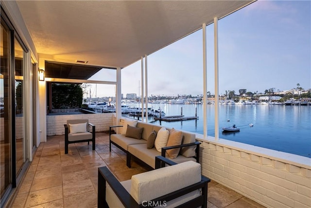 exterior space featuring an outdoor living space and a water view