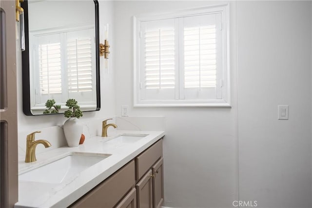 bathroom with a sink and double vanity
