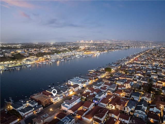 drone / aerial view featuring a water view and a view of city