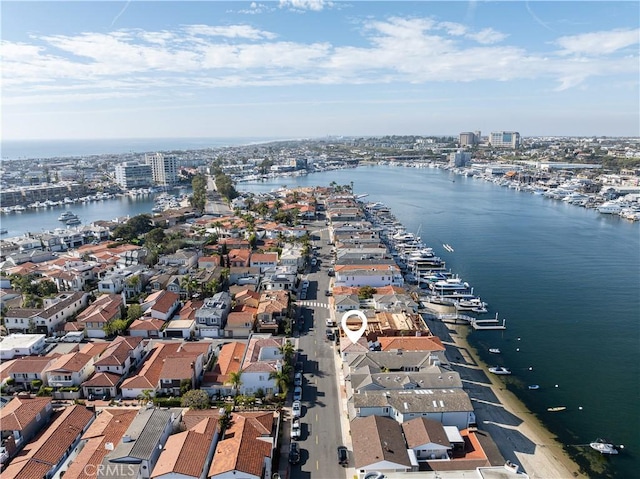 drone / aerial view with a city view, a water view, and a residential view
