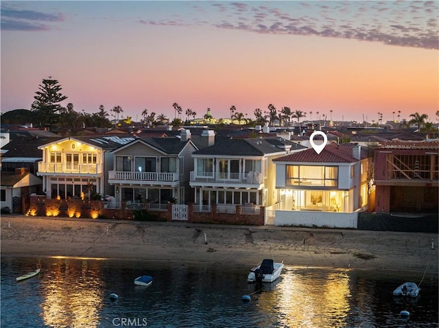 rear view of property with a water view and a residential view