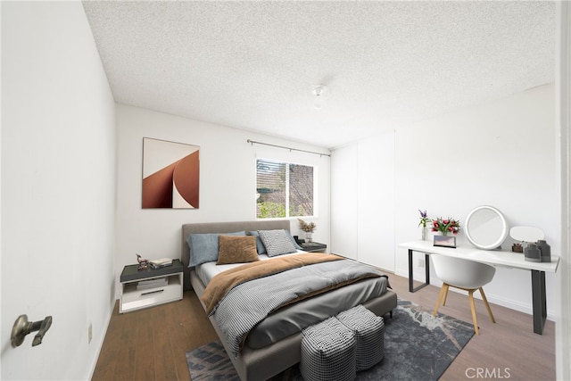 49 Village Loop Rd, Pomona, CA 91766 - bedroom featuring a textured ceiling, wood finished floors, and baseboards
