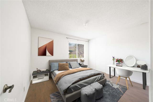49 Village Loop Rd, Pomona, CA 91766 - bedroom featuring a textured ceiling and wood finished floors