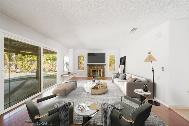 49 Village Loop Rd, Pomona, CA 91766 - living room with wood finished floors, a textured ceiling, baseboards, and a fireplace