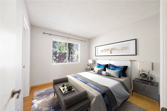 49 Village Loop Rd, Pomona, CA 91766 - bedroom featuring light wood finished floors and a textured ceiling