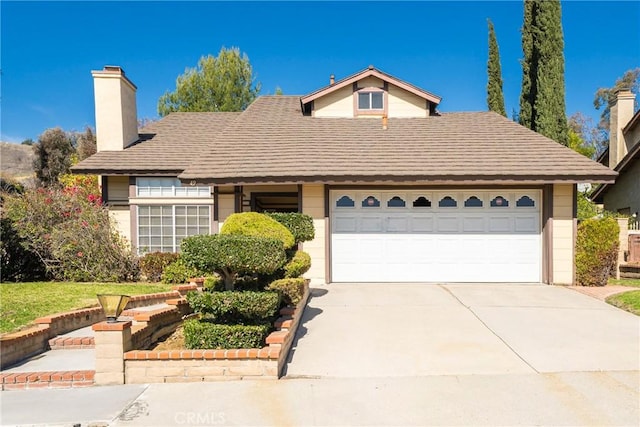 49 Village Loop Rd, Pomona, CA 91766 - view of front of house with a chimney, concrete driveway, and a garage
