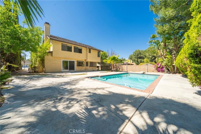 49 Village Loop Rd, Pomona, CA 91766 - view of swimming pool with a patio area, a fenced backyard, and a diving board