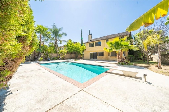 49 Village Loop Rd, Pomona, CA 91766 - view of pool with a patio area, a fenced backyard, and a diving board