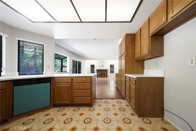 49 Village Loop Rd, Pomona, CA 91766 - kitchen featuring dishwashing machine, brown cabinetry, and light countertops