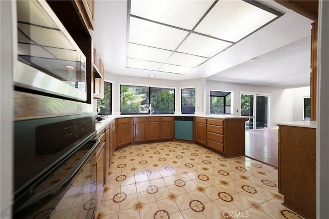 49 Village Loop Rd, Pomona, CA 91766 - kitchen with black oven, dishwashing machine, healthy amount of natural light, and brown cabinetry