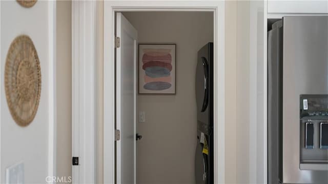 corridor with stacked washing maching and dryer