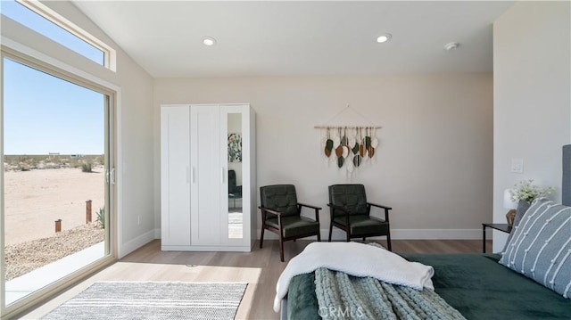 bedroom featuring light wood finished floors, recessed lighting, and baseboards